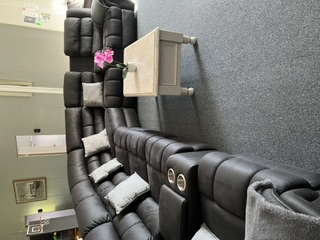 Main lounge with large leather modular recliner lounges in the 5 bedroom apartment