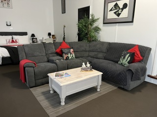 Studio living area with large corner recliner lounge and coffee table
