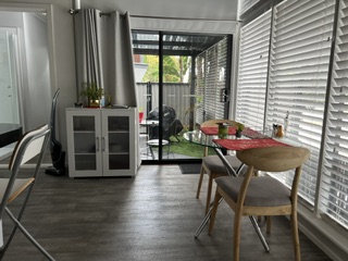 Dining table for two beside the sliding door out to the private courtyard