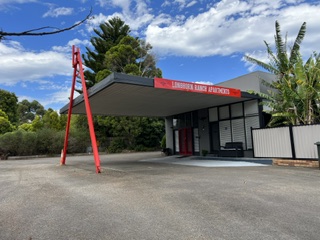 Entrance to Longhorn Ranch Apartments with large undercover parking