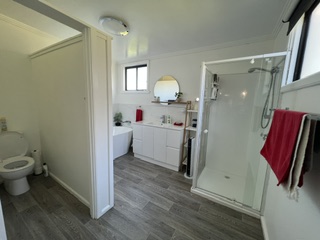 Bathroom with bathtub, shower, vanity and separate toilet